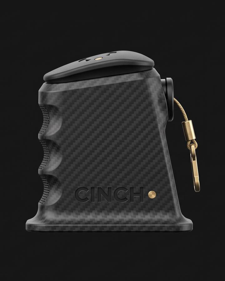 Cinch Loader, Canik fit. Black carbon fiber nylon magazine loader in side view on a dark ground, three finger scallops in profile, CINCH debossed on the side, a brass cord and swivel clip hanging from the top.